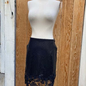 Black Stretch sequin mini skirt with appliquéd lace trim hem. SZ M-L