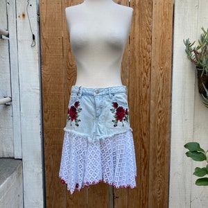 Recycled patchwork denim and lace mini skirt with floral appliqués front and trimmed hem details SZ M