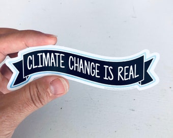 May include: A black and blue banner sticker with the text "Climate Change is Real".