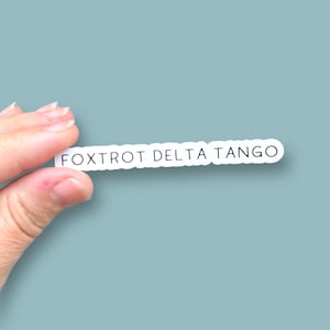 May include: White sticker with the text "FOXTROT DELTA TANGO" in black lettering.