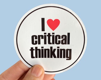 May include: White round sticker with black text that reads "I love critical thinking" and a red heart.