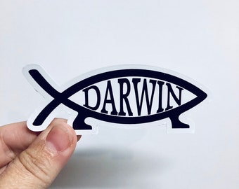 May include: A black and white sticker of a fish with the word "DARWIN" inside. The sticker is on a white background.
