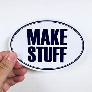 May include: White oval sticker with black text that reads "MAKE STUFF" and a website address at the bottom.