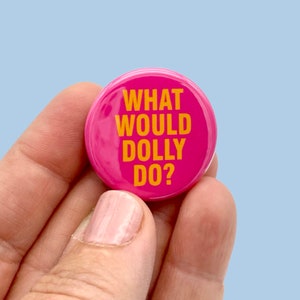 May include: Pink button with the text "What Would Dolly Do?" in yellow letters.