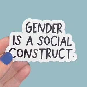 May include: White sticker with black text that reads "Gender is a social construct."