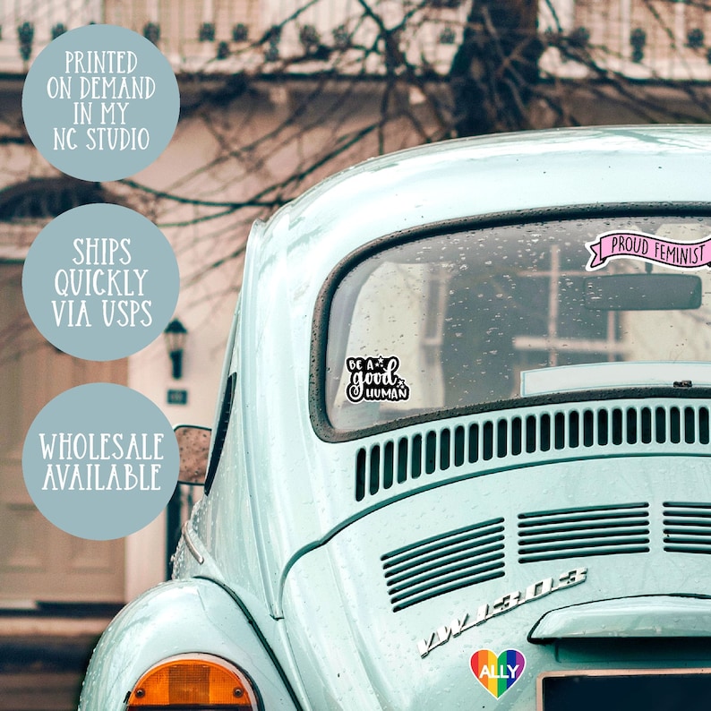 May include: A blue Volkswagen Beetle with several stickers on the back window. The stickers say "Be a good human", "Proud Feminist", and "Ally".