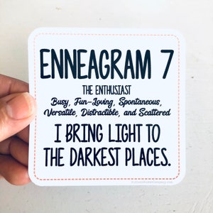 May include: White sticker with black text that reads "ENNEAGRAM 7 THE ENTHUSIAST Busy, Fun-Loving, Spontaneous, Versatile, Distractible, and Scattered I BRING LIGHT TO THE DARKEST PLACES. AnthemStickerCompany.com"