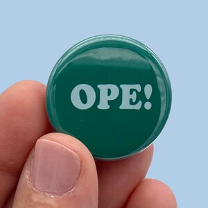 May include: A green button with white text that reads "OPE!"