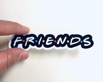 May include: Black and white sticker with the word "FRIENDS" in a stylized font. The letters are outlined in white and have colorful dots between them.