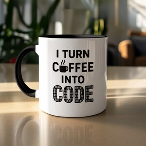 May include: White coffee mug with a black interior and handle. The mug features the text "I TURN COFFEE INTO CODE" in black, with a coffee cup graphic and binary code. A perfect gift for programmers and coders.