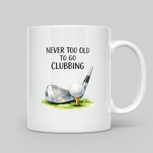 White mug with text "Never too old to go clubbing" and a golf ball on a tee.