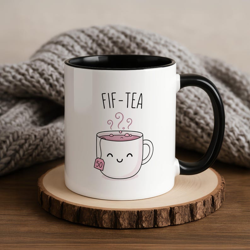 Mug with a smiling teacup graphic and "FIF-TEA" text.
