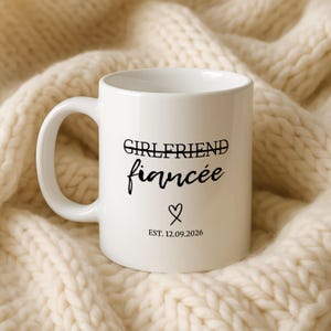White mug with "Girlfriend fiancée" and "Est. 12.09.2026" text on it.