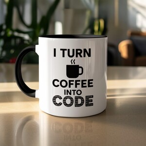 May include: White ceramic coffee mug with a black interior and handle. The mug features the text "I TURN COFFEE INTO CODE" in black, along with a coffee cup graphic and binary code accents. The mug is approximately 4 inches tall.