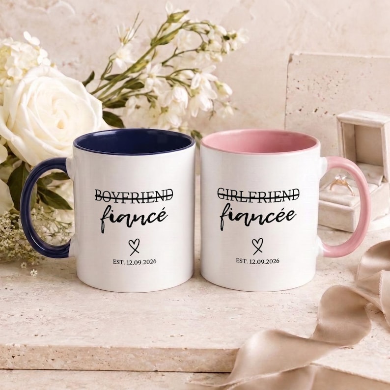 Boyfriend Fiancé and Girlfriend Fiancée mugs with engagement ring and flowers.