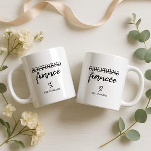 "Boyfriend fiancé" and "Girlfriend fiancée" mugs with heart and "EST. 12.09.2026" text.