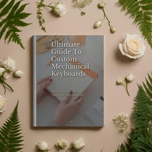 Peut inclure: Un livre intitulé "Ultimate Guide To Custom Mechanical Keyboards" avec le sous-titre "Sound profiles and soldering-free assembly". Le livre est tenu par des mains et entouré de roses blanches, de fougères et d'autres verdure sur un fond beige.