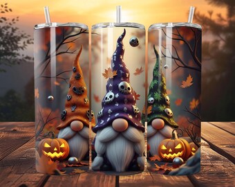 May include: Three Halloween-themed tumblers with gnome designs. Each tumbler features a gnome with a tall hat adorned with skulls, a white beard, and a carved pumpkin. The background includes autumn leaves and a sunset.