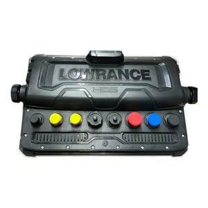 May include: A black Lowrance HDS marine electronics device. The device has the brand name embossed on the top and features several colored buttons: yellow, red, and blue. The word "DOMINATE" is printed on the bottom.