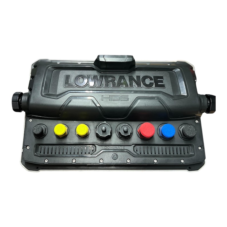 May include: A black Lowrance HDS marine electronics device. The device has the brand name embossed on the top and features several colored buttons: yellow, red, and blue. The word "DOMINATE" is printed on the bottom.