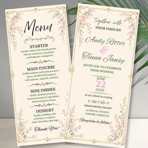 Könnte beinhalten: Ein Hochzeitskarten-Set bestehend aus Einladung und Menükarte auf cremefarbenem Papier mit goldenen Ornamenträndern und Blumenmotiven. Der Text enthält die Namen Andy Ritter und Tinna Jansy, das Datum 22. Juni 2026 sowie ein vollständiges Menü.