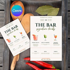 May include: Two bar menu cards with signature drink illustrations, including Honey Deuce, Boul Evardier, and Orange Blossom. Wooden spoons, red peppers, and bay leaves are arranged around the cards. The text "THE BAR signature drinks" is visible.