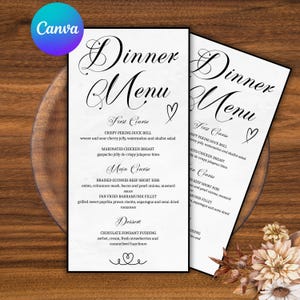 May include: Two white dinner menus with elegant cursive text, featuring a menu with courses like Crispy Peking Duck Roll and Chocolate Fondant Pudding. The menus are on a wooden surface, with a Canva logo in the top left.
