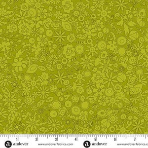 May include: A fabric with a repeating pattern of stylized flowers and leaves in shades of green. The design includes various floral shapes, creating a dense, all-over pattern. The fabric has a ruler along the bottom edge.