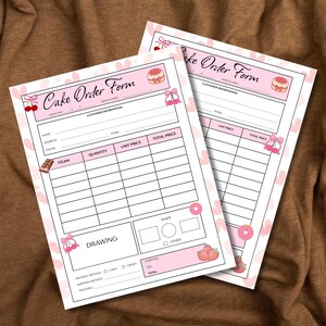 May include: Two pink and white "Cake Order Form" sheets. The forms have sections for customer information, item details, and totals. Decorative elements include cherries, bows, cakes, donuts, and strawberries. The forms are on a brown surface.