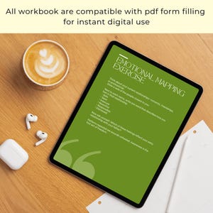 May include: A digital tablet displays an "Emotional Mapping Exercise" on a green background. The text includes prompts about relationships and feelings. A cup of coffee, white earbuds, and a charging case are on a wooden surface.