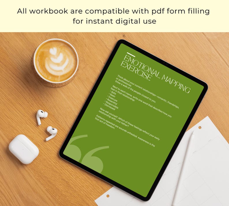 May include: A digital tablet displays an "Emotional Mapping Exercise" on a green background. The text includes prompts about relationships and feelings. A cup of coffee, white earbuds, and a charging case are on a wooden surface.