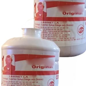 May include: Two white plastic bottles with red and white labels. The labels feature text and a logo. The word "Original" is visible on the label. The bottles appear to be for a product from "CABINET LA".