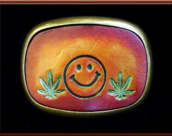 HAPPY FACE and POT Leaf Design, Handcrafted and Tooled Leather Belt Buckle • Fits up to 1 3/4" Wide Belt.  2 1/2" High X 3 1/4" Long.