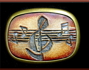 G CLEF MUSIC Design, Handcrafted and Tooled Leather Belt Buckle • Fits up to 1 3/4" Wide Belt.  2 1/2" High X 3 1/4" Long.