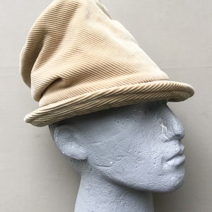 Slouchy top hat made from beige recycled corduroy fabric.