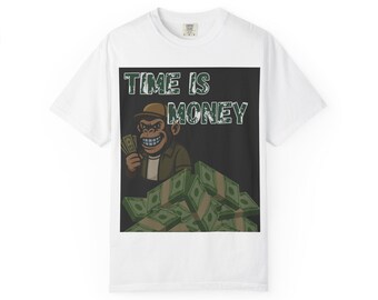 May include: White t-shirt with a graphic featuring a cartoon monkey holding money, sitting on a pile of cash. The text "TIME IS MONEY" is above the monkey. The monkey is wearing a brown hat and jacket.