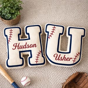 May include: A white ceramic mug with a black handle and the text "But First, Coffee" in a black, handwritten-style font. The mug sits on a white surface.