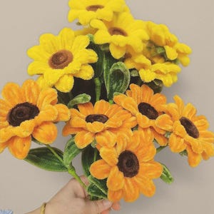 May include: A white ceramic mug with a black handle and the text "But First, Coffee" in a handwritten style. The mug is on a white surface. The mug is approximately 4 inches tall.