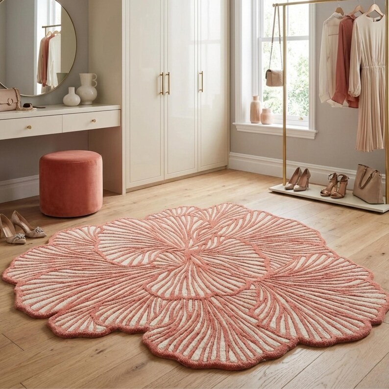 Irregular coral pink abstract area rug with organic sculpted pattern styled in a modern living room