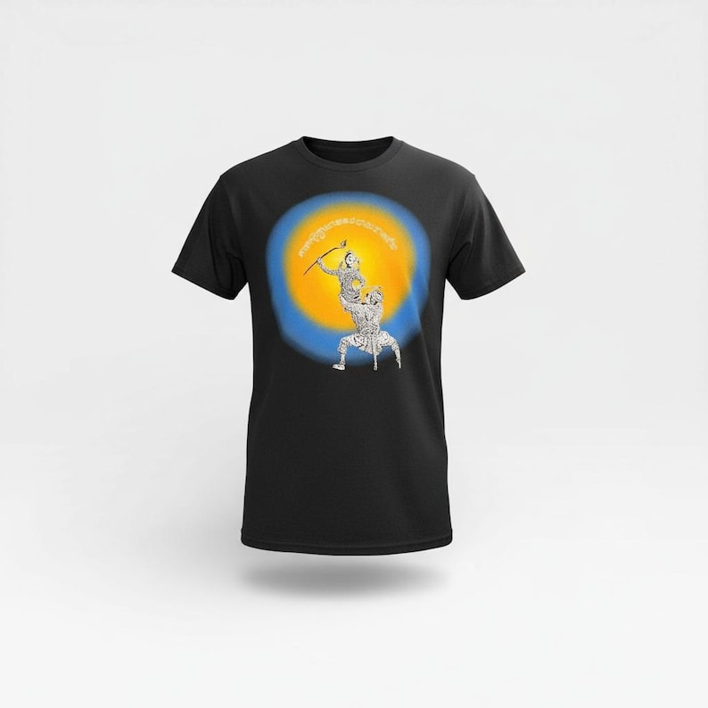 K&ouml;nnte beinhalten: Schwarzes T-Shirt mit einer Grafik von zwei Figuren, eine &uuml;bereinander, mit Pfeil und Bogen, vor einem gelb-blauen kreisf&ouml;rmigen Hintergrund. Die Figuren sind wei&szlig; mit schwarzen Details. Der Text im Bild ist unklar.