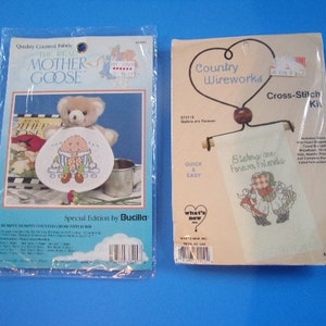 May include: Two cross-stitch kits, one featuring a mother goose and the other featuring two girls with the text "Sisters are Forever Friends".