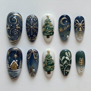 May include: A set of ten artificial nails with Christmas-themed designs. Each nail features a different design, including a Christmas tree, reindeer, snowflakes, and a gingerbread house, all in a festive color palette of gold, white, and blue.
