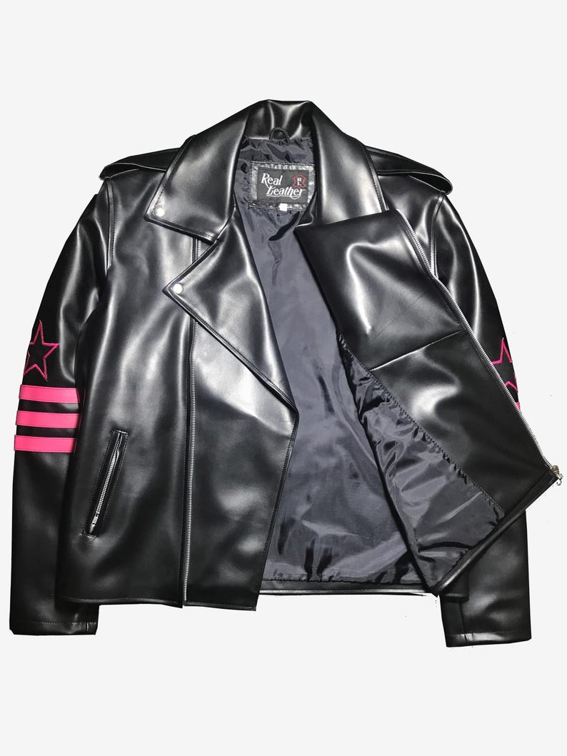 May include: Black leather jacket with a classic biker style, featuring a notched collar, asymmetrical zipper, and pink star and stripe accents on the sleeves. The jacket has a "Real Leather" label.