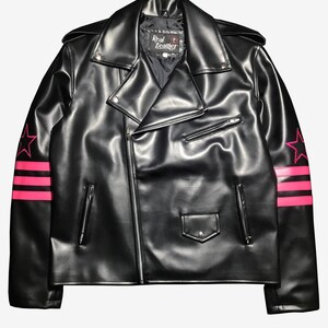 May include: Black leather jacket with a classic biker style, featuring a notched collar, asymmetrical zip closure, and multiple pockets. The sleeves are adorned with pink star and stripe designs. The label reads "Real Leather".