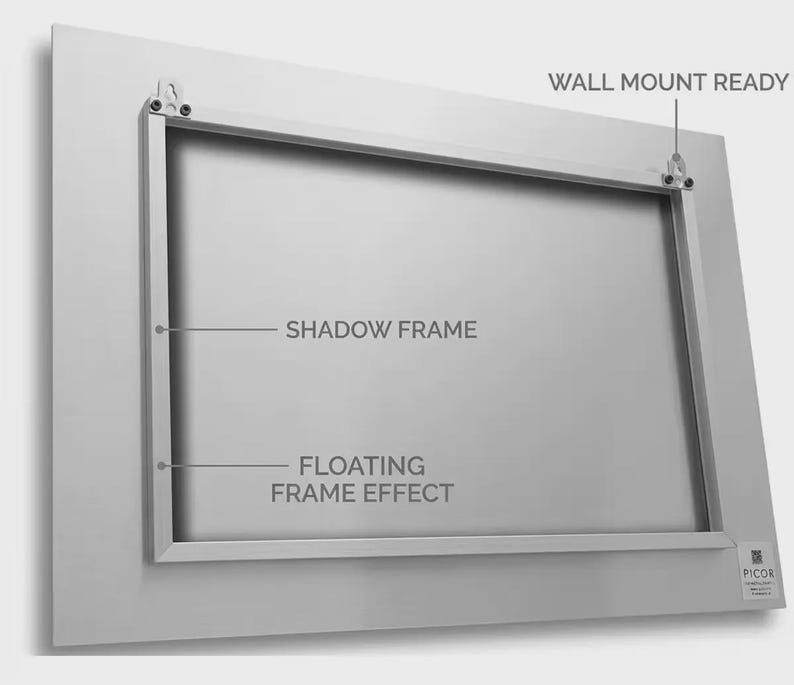 May include: A rectangular silver metal panel featuring a shadow frame on the reverse side. The back includes two wall mount ready brackets. Text labels indicate SHADOW FRAME, FLOATING FRAME EFFECT, and WALL MOUNT READY. A small logo tag reads PICOR.