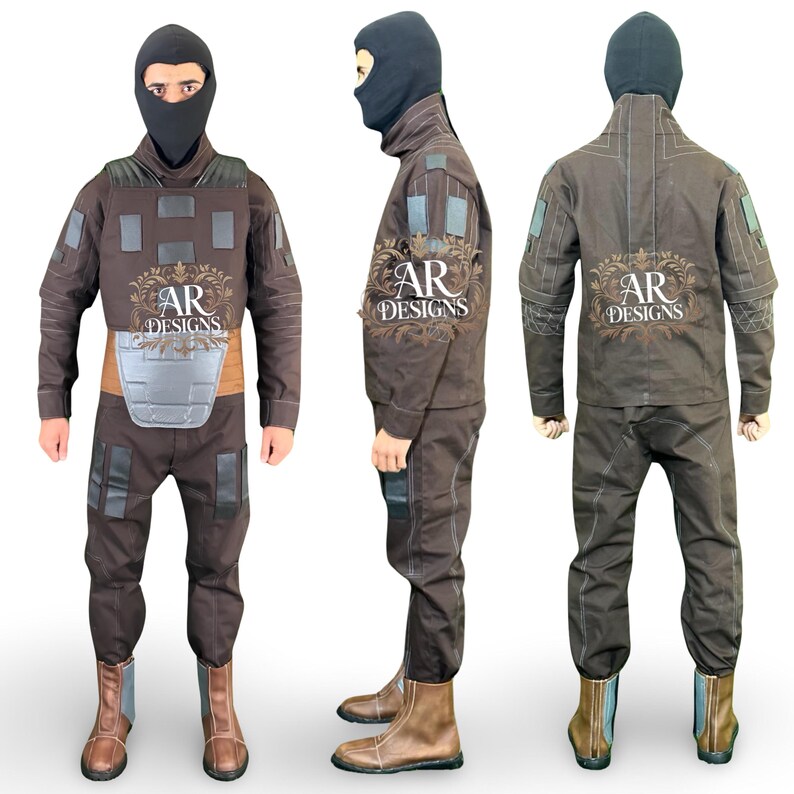 May include: A brown tactical jumpsuit with a black balaclava, featuring a chest plate and multiple pockets. The suit includes brown boots and the text "AR DESIGNS" on the front and back. The jumpsuit is designed for protection and concealment.