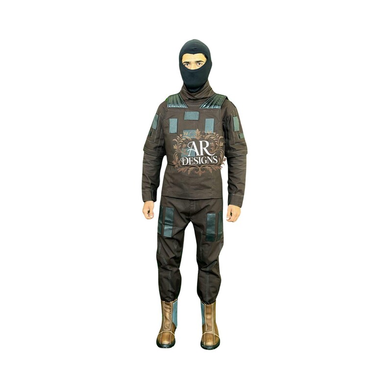 May include: A brown tactical suit with a black balaclava. The suit has multiple pockets and patches, with the text "AR DESIGNS" on the chest. The boots are brown and tan.