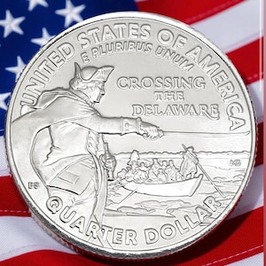 May include: A silver quarter dollar coin featuring an image of George Washington leading troops across the Delaware River. The coin is set against a backdrop of the American flag, with the words "United States of America" and "Quarter Dollar" inscribed.