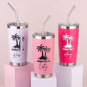 May include: Three stainless steel tumblers in lavender, pink, and hot pink, each with a silver lid and straw. The tumblers feature a black palm tree design with the text "Bonnet Creek" and a name in a script font.