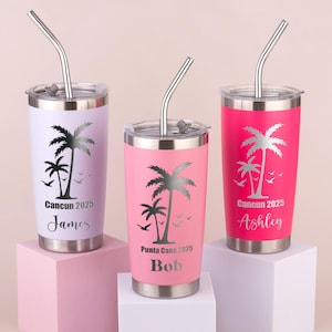 May include: Three stainless steel tumblers in pink, lavender, and hot pink, each with a silver lid and straw. The tumblers feature a palm tree design and the text "Cancun 2025" or "Punta Cana 2025" with a name below.